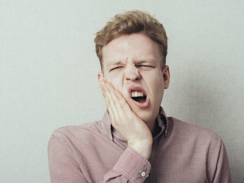 a man suffering from tooth pain